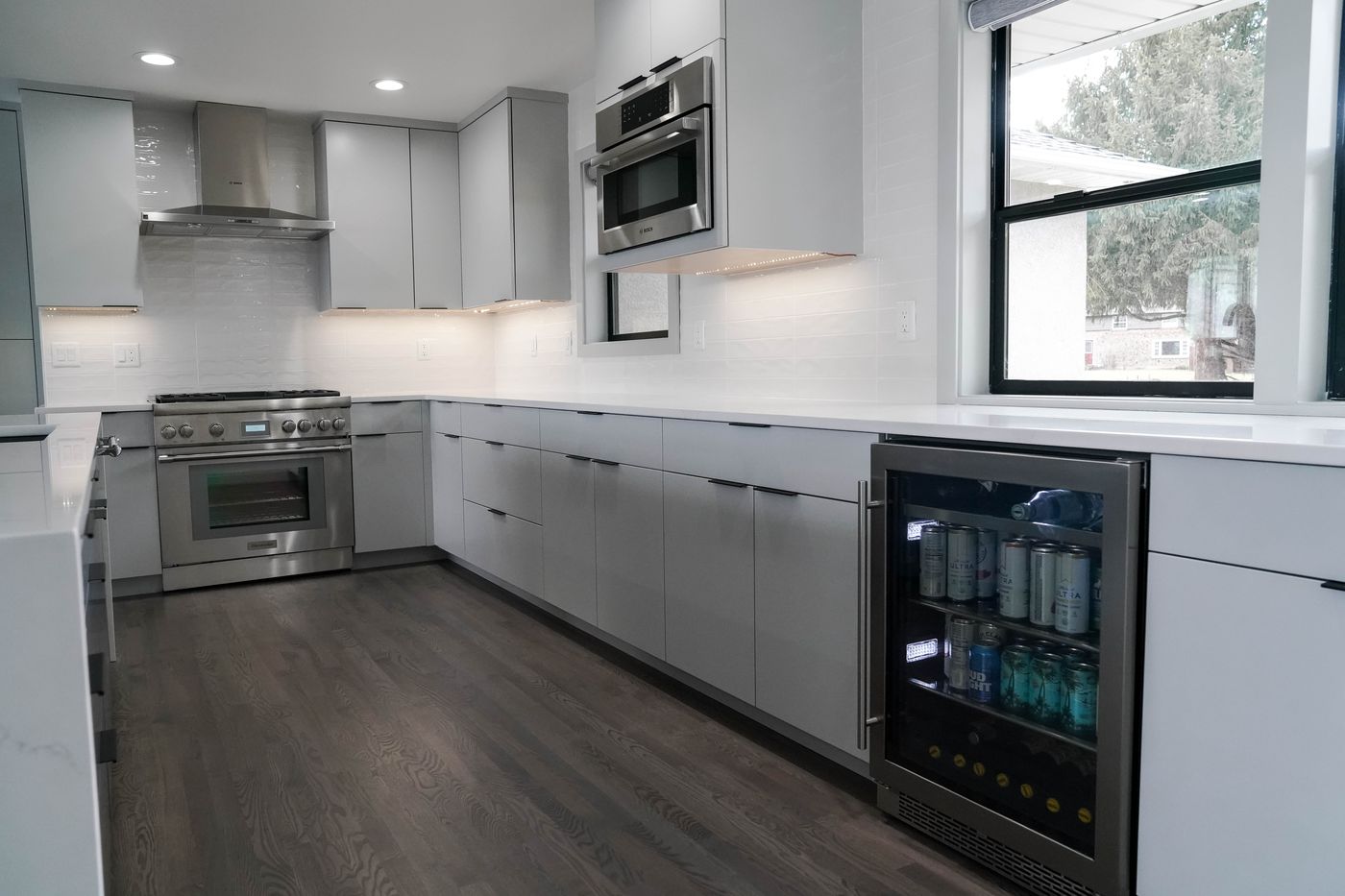 Grey kitchen perimeter with a Bosch range, wall oven, and beverage fridge